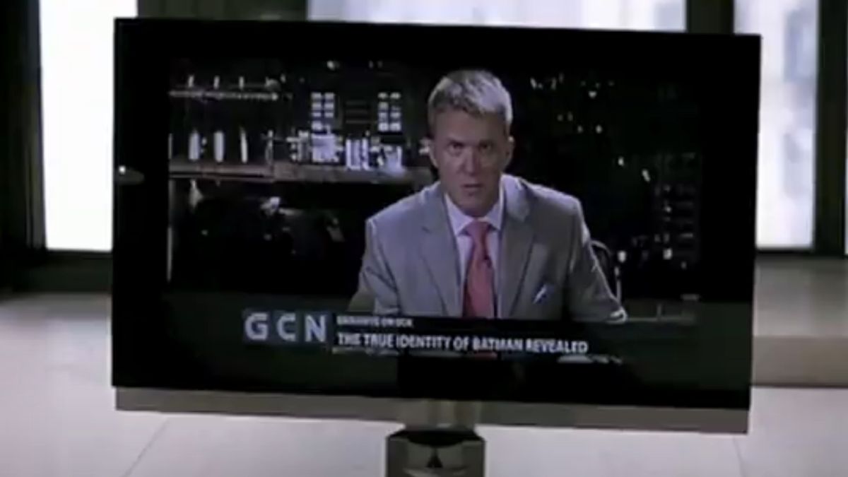 Anthony Michael Hall delivering the news on GCN from a TV screen in The Dark Knight