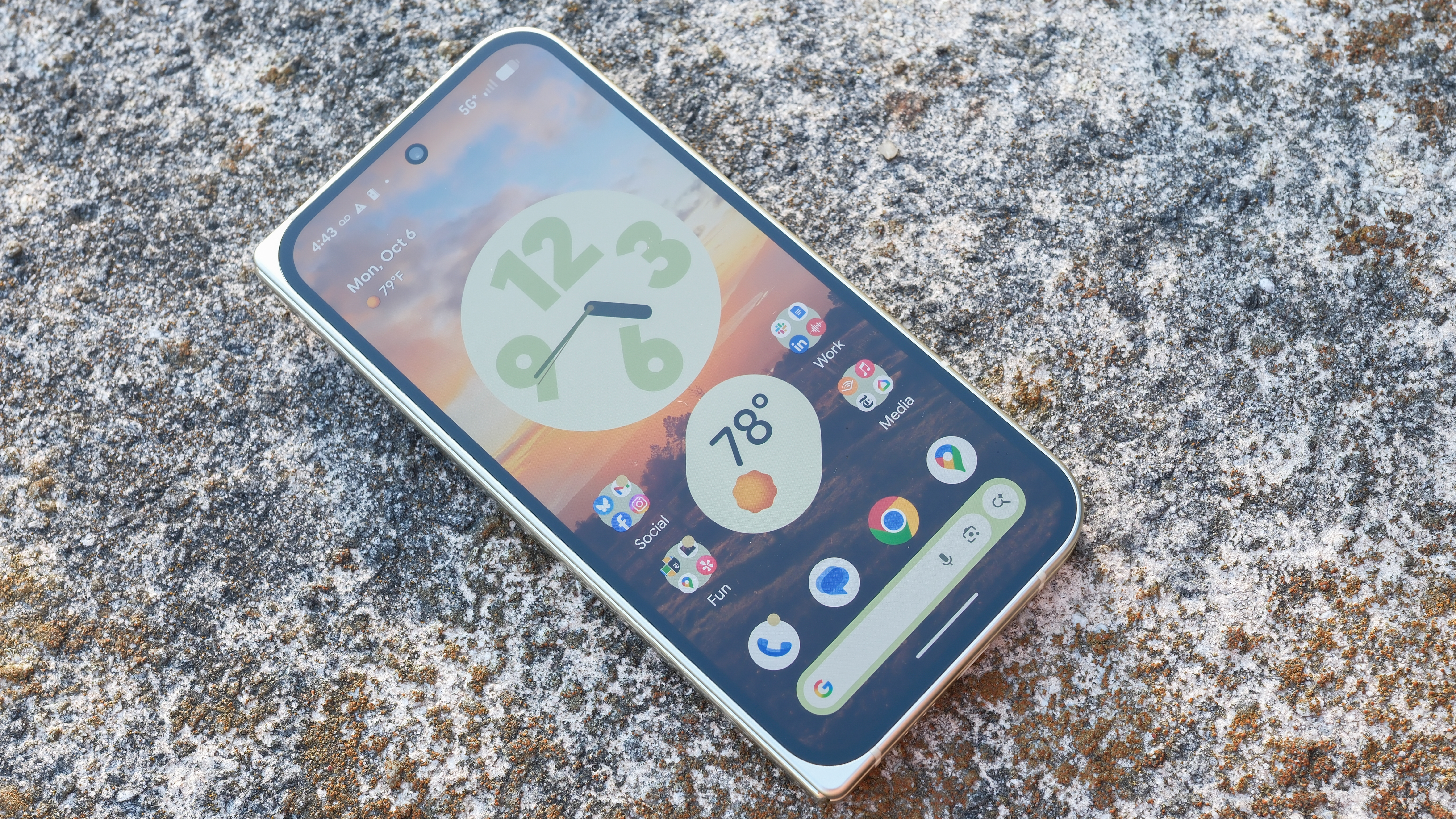 Google Pixel 10 Pro Fold in Jade green outside at a flower garden on a sunny day