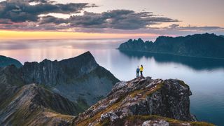 Two hikers on mountaintop