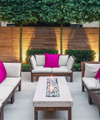 City garden with patio space filled with furniture and lights