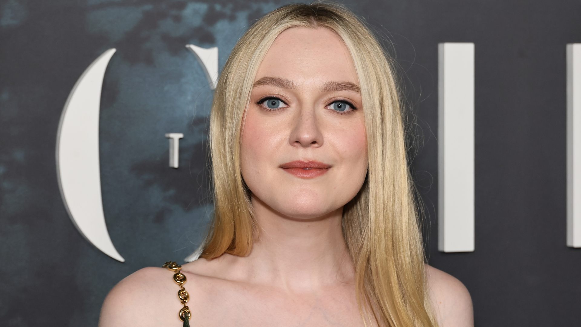 Dakota Fanning wearing a dress on a red carpet