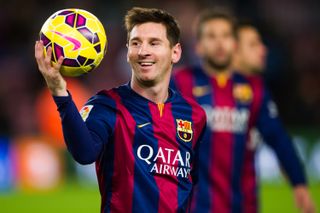 Lionel Messi with the match ball after scoring three goals for Barcelona against Espanyol in December 2014.