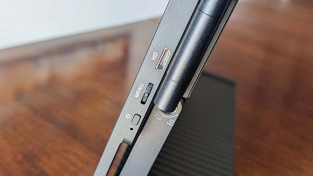 The power button, menu dial, and mini HDMI port on the side of a JSAUX FlipGo Horizon monitor.