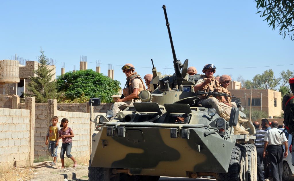 A picture taken on September 9, 2017 shows Russian military vehicles carrying humanitarian aid parcels in the northeastern Syrian city of Deir el-Zour 