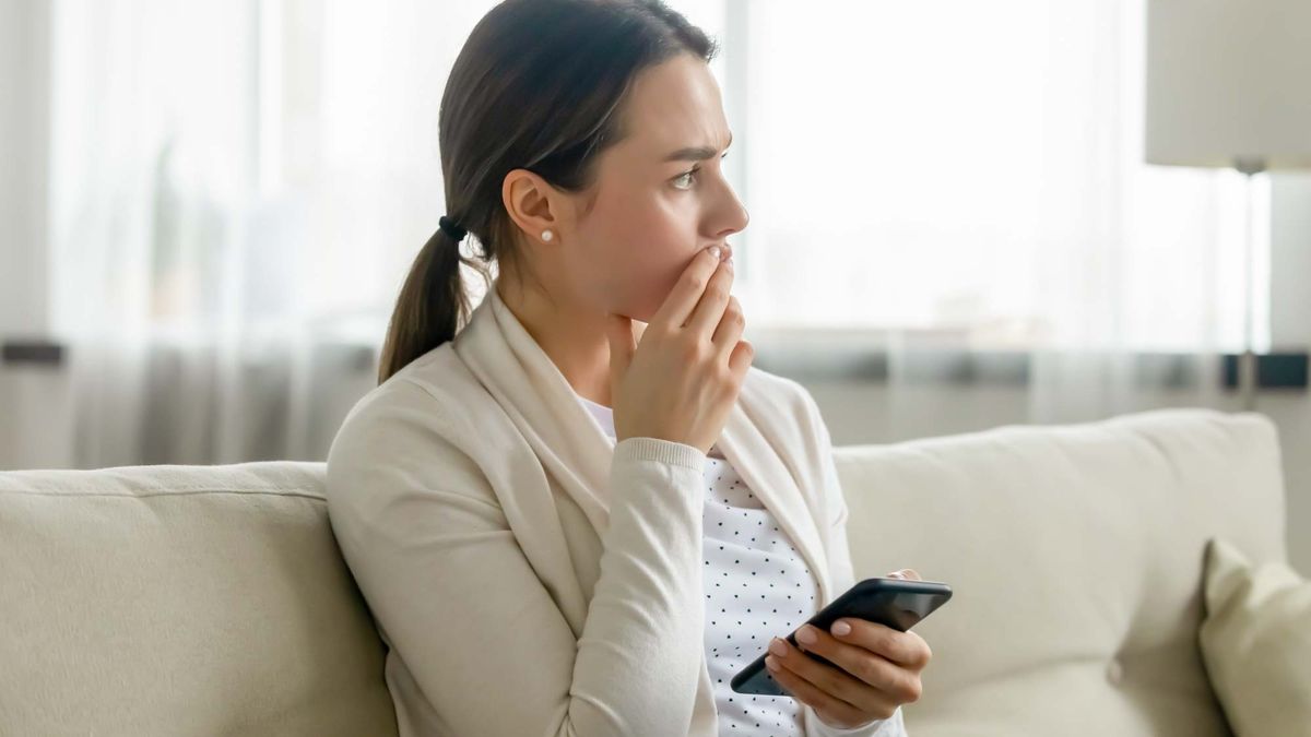 A nervous woman looking at her phone