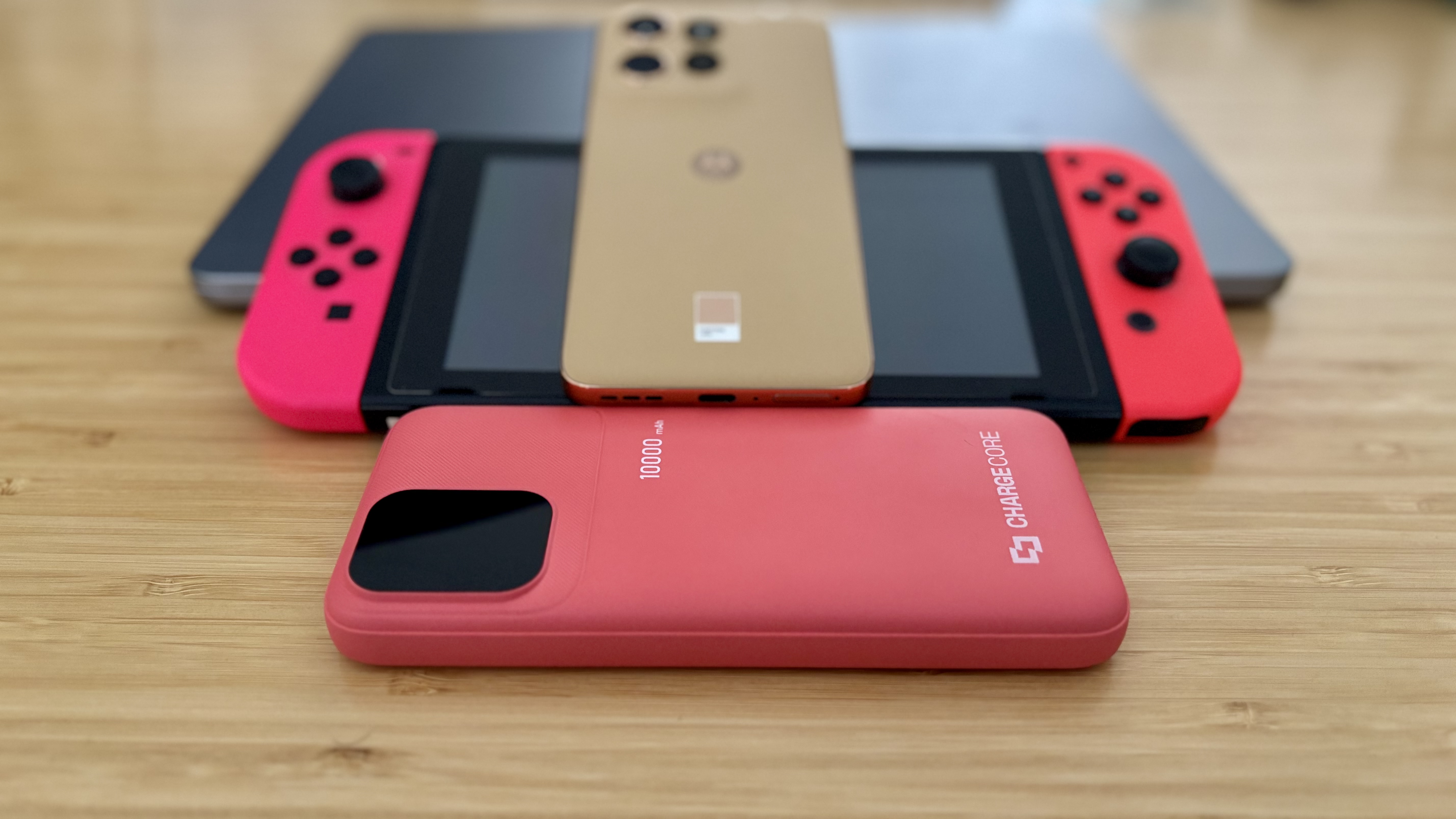 Laser ChargeCore 10K Max power bank and three devices ready for charging