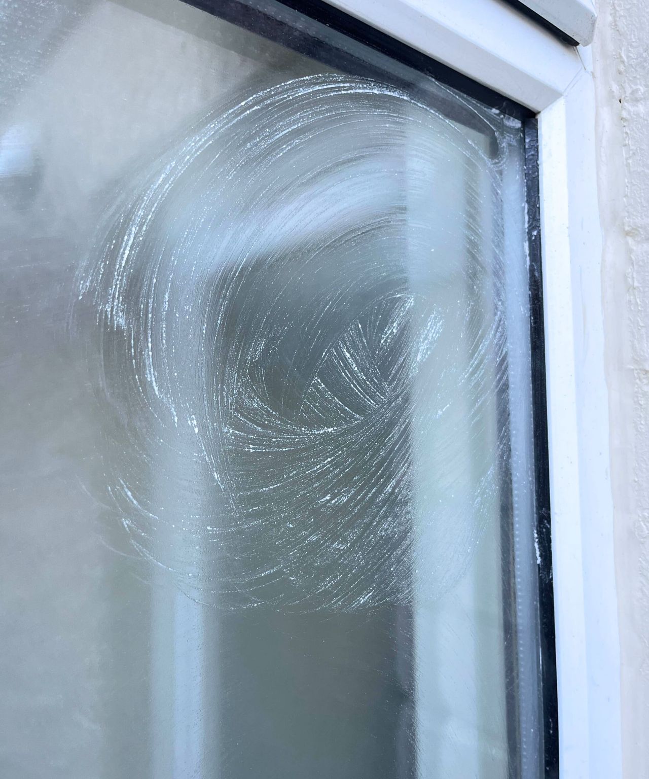 A baking soda paste smeared on a glass window