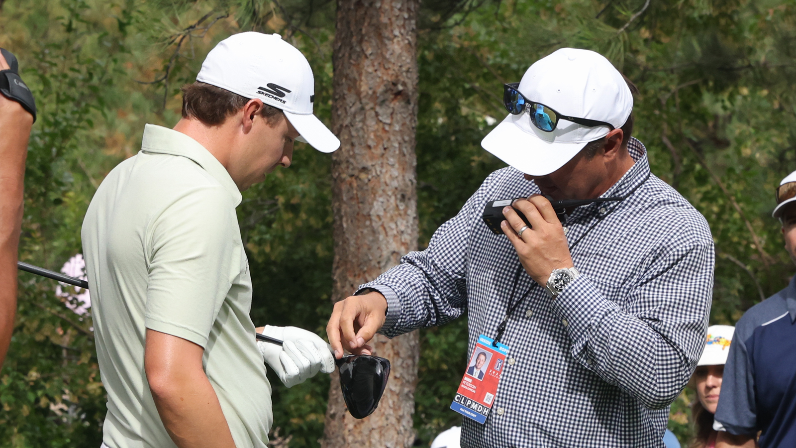 Matt Fitzpatrick and a referee look at a cracked driver
