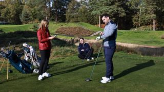 Golfers waiting on the tee