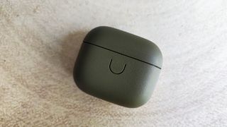 Urbanears Boo review: charging case closed on a wooden table