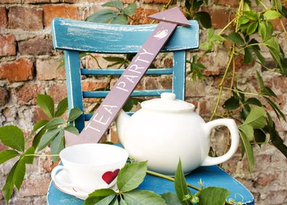 Tea Party Items And Plants On A Blue Chair