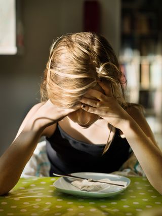 Girl sitting with hands in her head