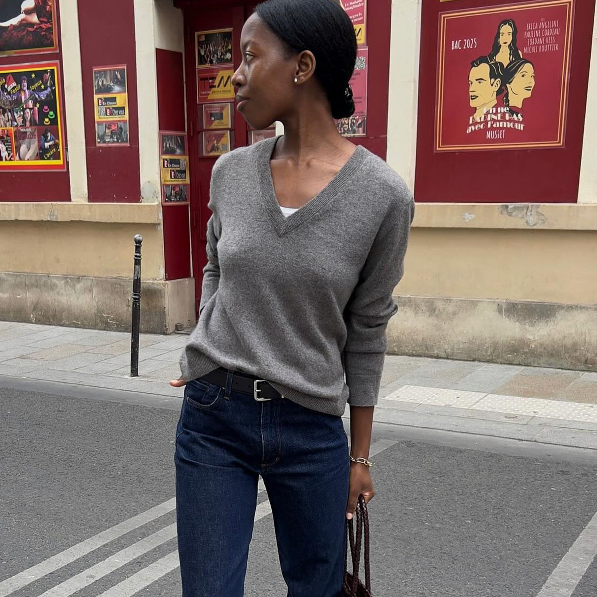 Woman in gray sweater and dark wash jeans