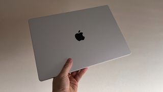 MacBook Pro 16-inch held up in one hand
