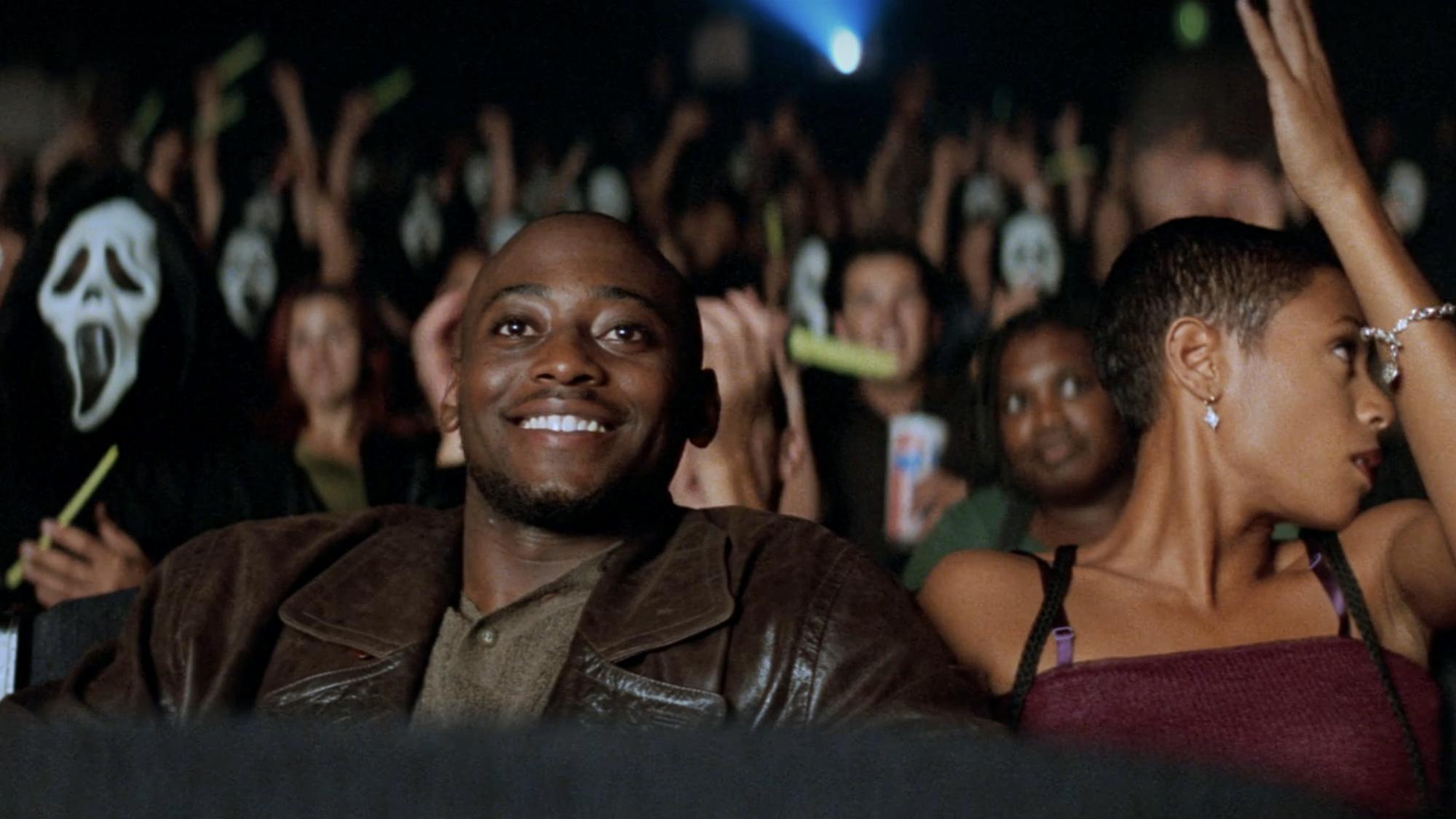 Mekhi Phifer and Jada Pinkett Smith play Phil Stevens and Maureen Evans Maureen Evans, sitting in the STAB screaning in Scream 2.