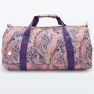 Urban Outfitters weekend bag with a paisley pink, purple and orange print with purple straps