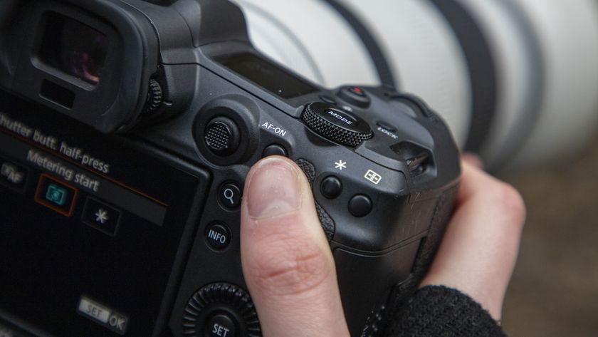 The close-up of the back of a Canon camera with a thumb hovering over the AF-ON button