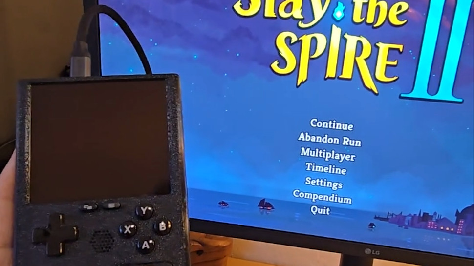 SteamBoy shown hooked up to an external monitor, playing Slay the Spire 2