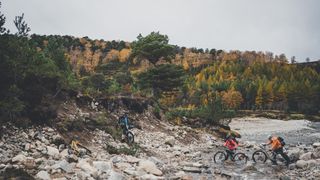 Bikers crossing river Feshie in Scotland