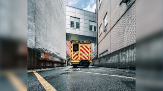 Ambulance car standing in front of a part of the BRI building