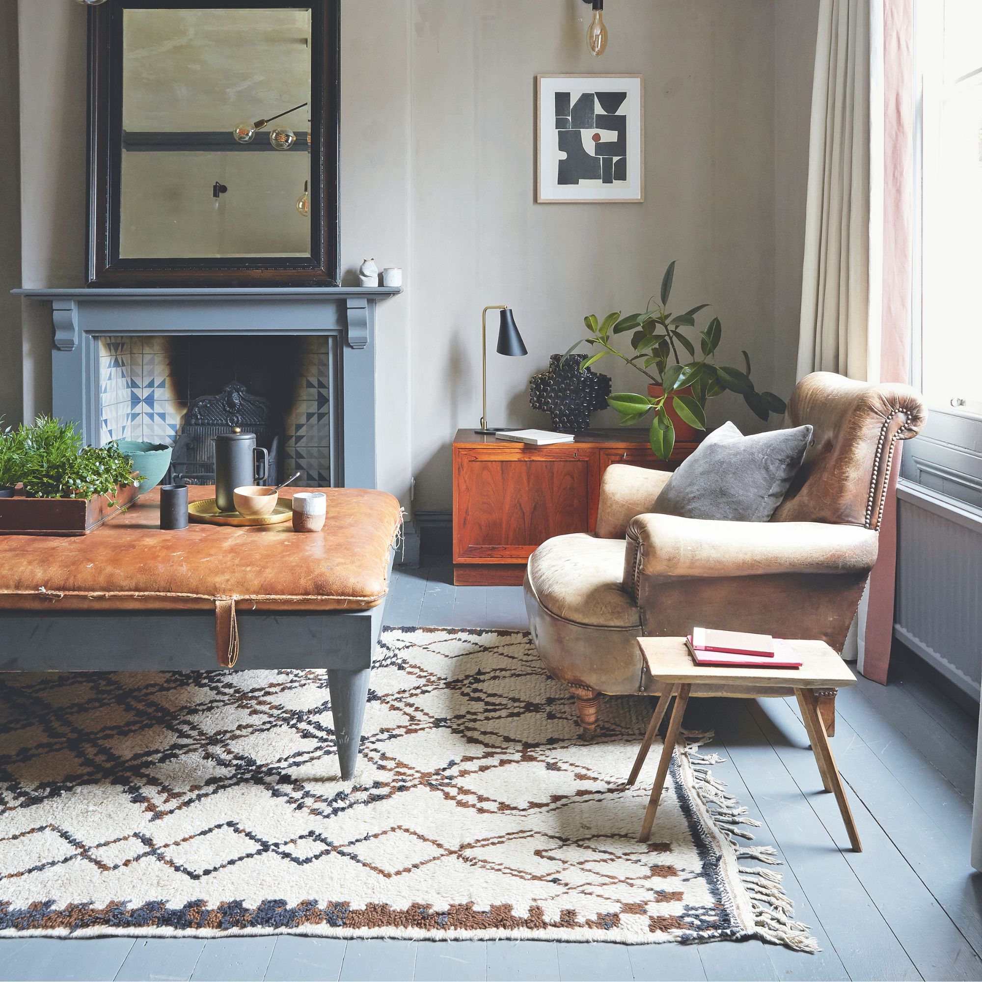 Beige living room with blue floorboards and a leather armchair