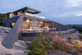 Hillside residence with infinity pool on rocks
