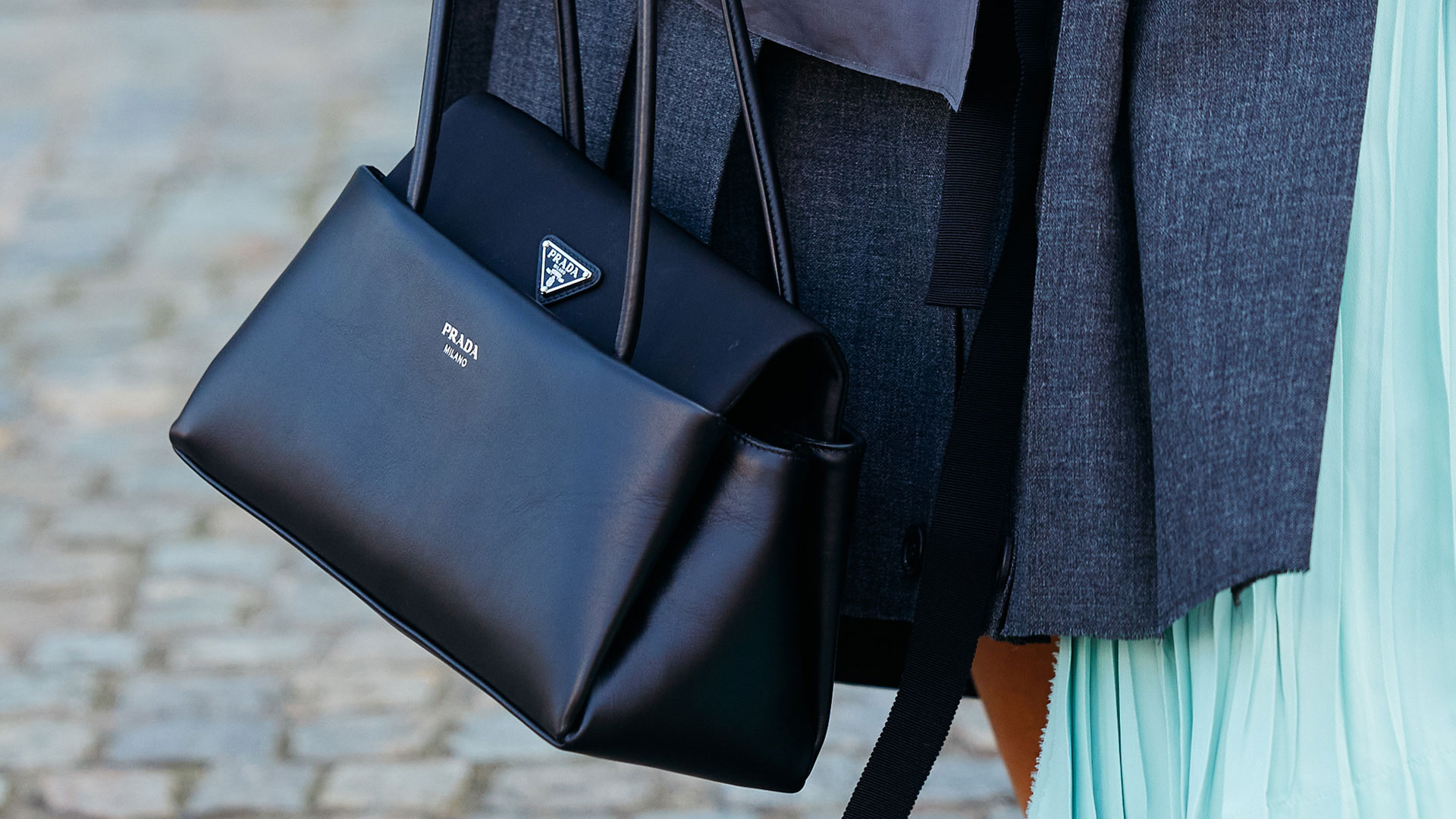 milan street style woman carrying prada passage bag