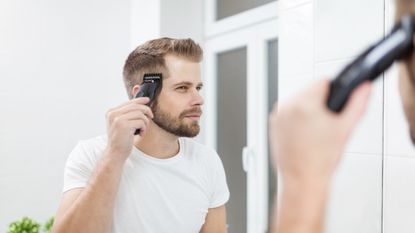 A man looking in the mirror and shaving the side of his head – these are the best hair clippers