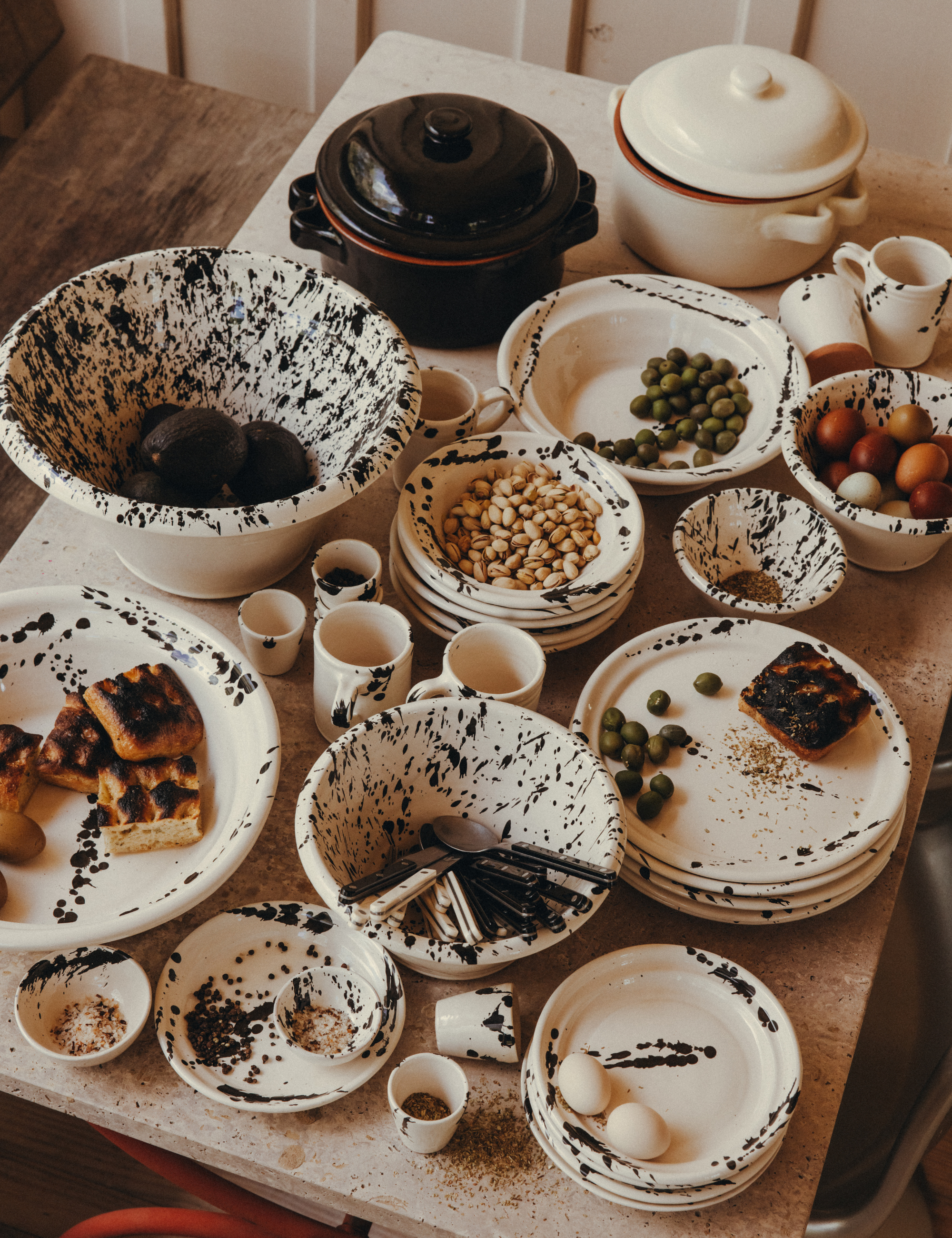 Leanne Ford x il Buco Vita splatter painted tableware styled with Italian bites and coordinating cutlery