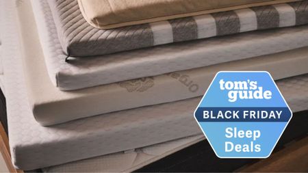 An image of a stack of mattress toppers with a blue Black Friday sleep deals badge in the bottom right-hand foreground.