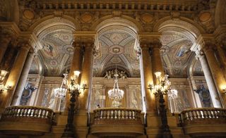 Palais Garnier opera house for Stella McCartney's presentation Heavy, crystal chandeliers and plush painted ceilings together with veined marble walls and stone pillars provided a theatrical elements