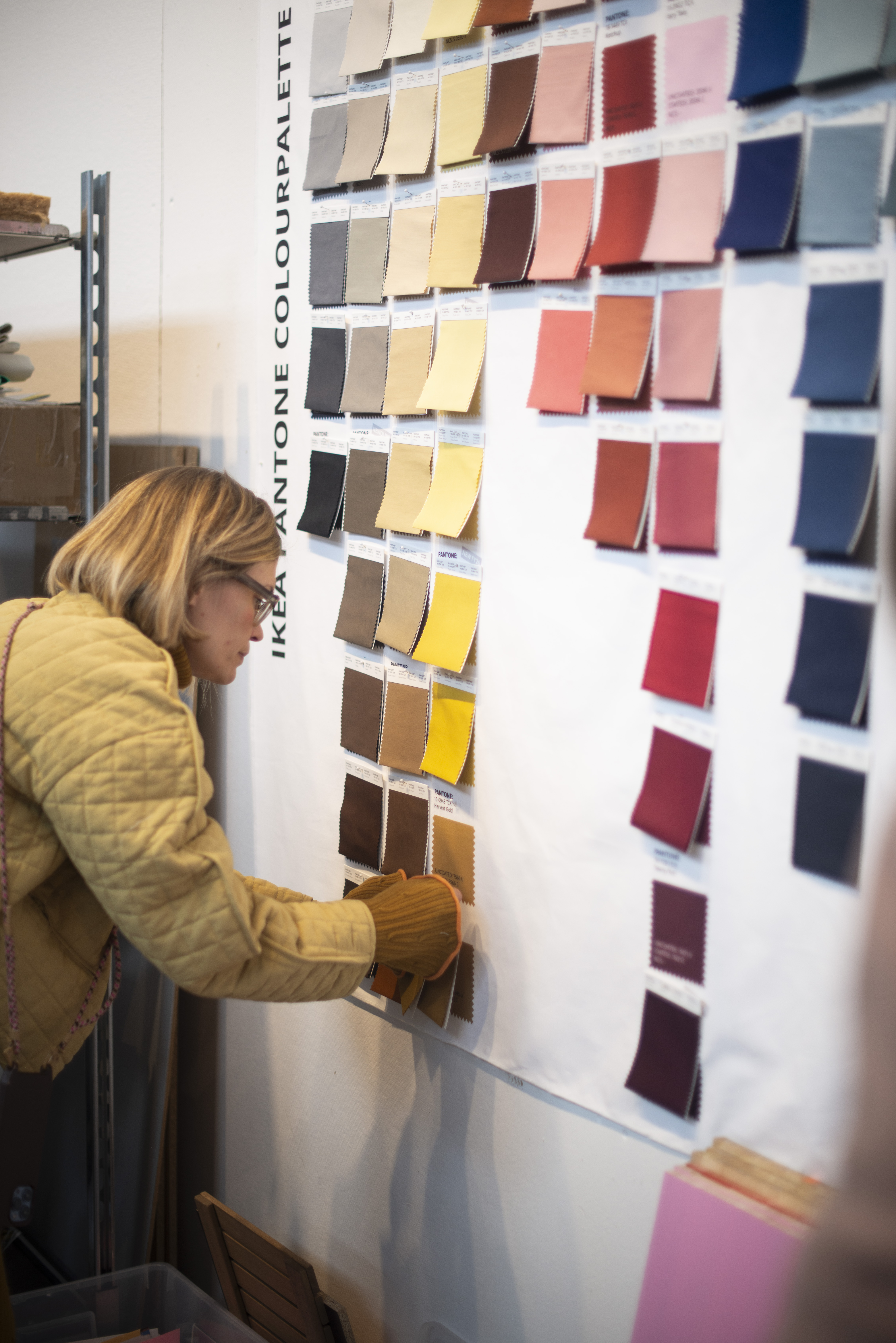 Swedish designer Teklan inspecting colour swatches in studio