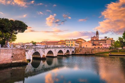 Rimini cityscape. Tiberius bridge famous sightseeing in Rimini at dawn. Summer sunrise in Rimini historic center. (Rimini cityscape. Tiberius bridge famous sightseeing in Rimini at dawn. Summer sunrise in Rimini historic center., ASCII, 114 components