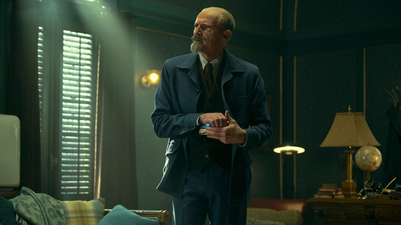Sir Reginald Hargreeves holds an item as he talks to someone off screen in The Umbrella Academy season 3