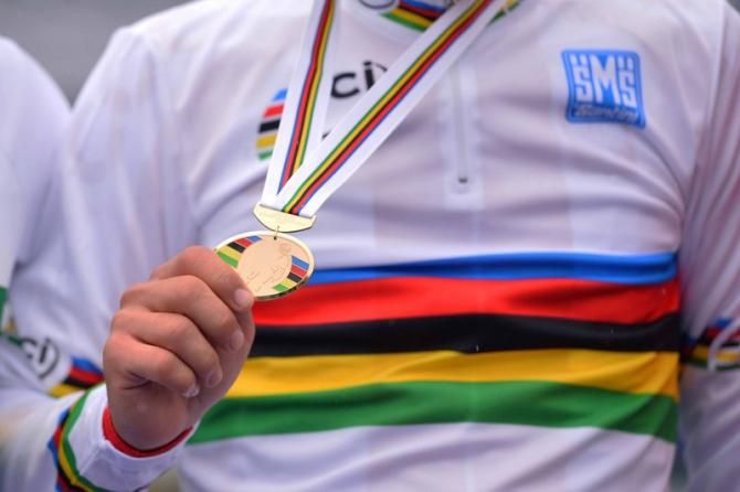 Michal Kwiatkowski (Poland) holds his gold medal aloft