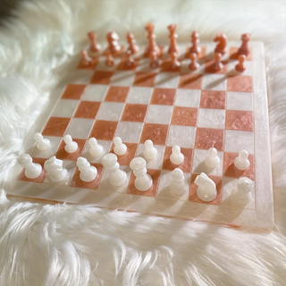 Pink and white resin chess set.