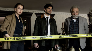 Ayşe Farsakoğlu (Yasemin Kay Allen), Mehmet Suleyman (Ethan Kai) and Çetin Ikmen (Haluk Bilginer) stand behind yellow police tape in The Turkish Detective