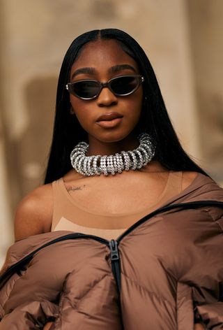 Milan fashion week spring 2025 street style photo of a Normani wearing oversized jewellery trend