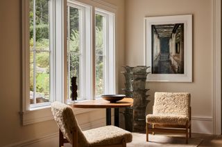 a beige room with shearling chairs