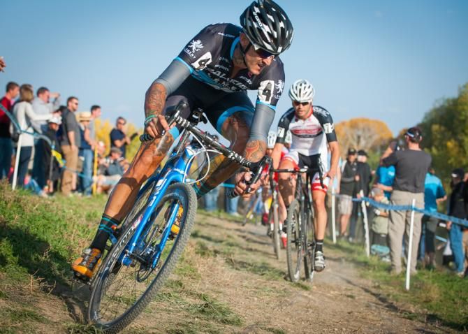 Ben Berden (Raleigh Clement) takes a dive into a sweeping downhill turn as Danny Summerhill (K-Edge) looks on. Boulder Cup.