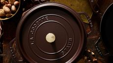A deep brown cast-iron Dutch oven viewed from above.