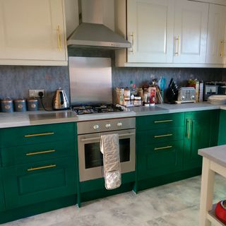 kitchen with gas stove and green cabinets