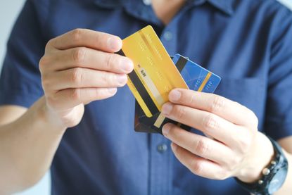 Man holding several credit cards
