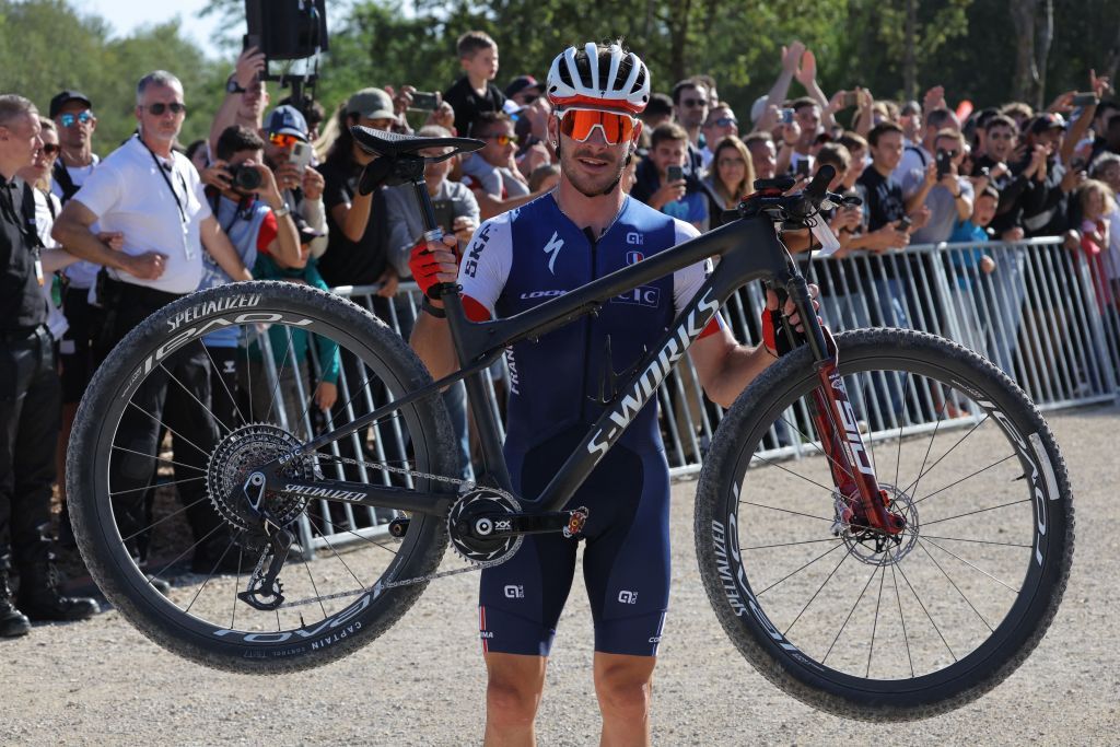 Frances Victor Koretzky poses with his bicycle after winning the Mens Elite Cross Country mountain biking test event at Elancourt Hill in Elancourt west of Paris on September 24 2023 Photo by Thomas SAMSON AFP Photo by THOMAS SAMSONAFP via Getty Images