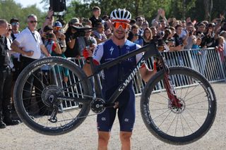 France's Victor Koretzky poses with his bicycle after winning the Men's Elite Cross Country mountain biking test event at Elancourt Hill in Elancourt west of Paris on September 24 2023 