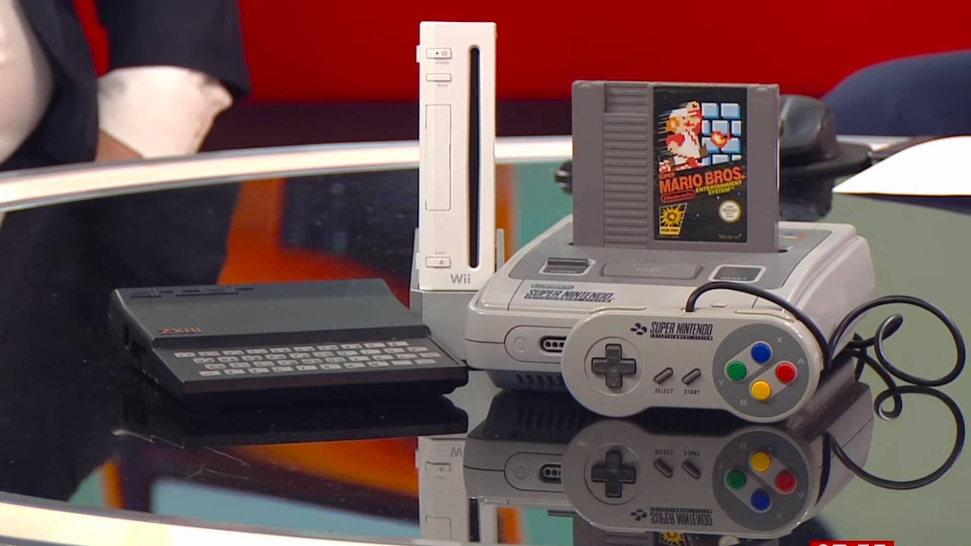 BBC Breakfast news table with ZX81, Nintendo Wii, and SNES with NES cart inserted.
