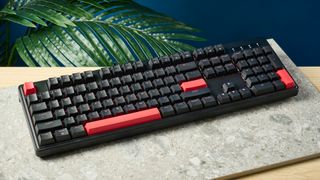 A black Lemokey X3 wired gaming keyboard with red keycaps