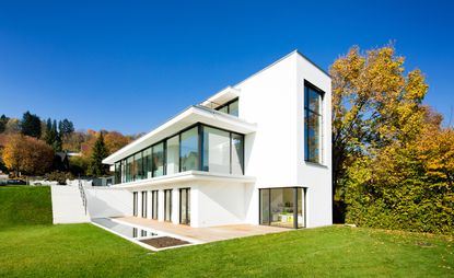 House exterior with white walls and grassland