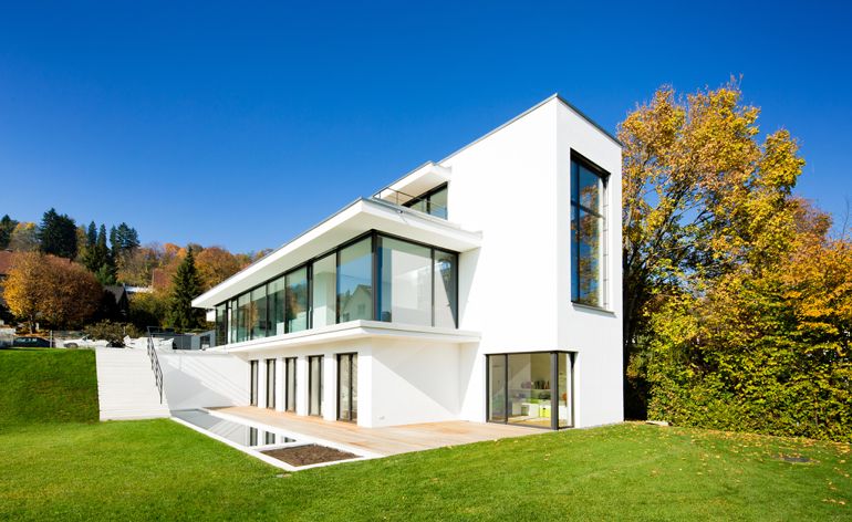 House exterior with white walls and grassland