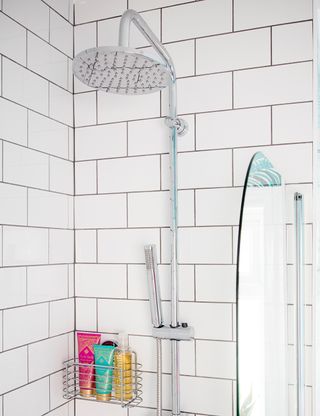 bathroom with white tiles wall and shower